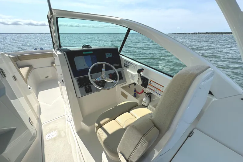 Slide: The Image of 2020 Pursuit DC 235 Dual Console boat interior with "Procrastinator" engraved panel. - 19