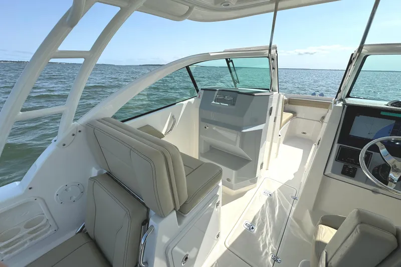 Slide: The Image of 2020 Pursuit DC 235 Dual Console boat interior with modern dashboard and seating. - 23