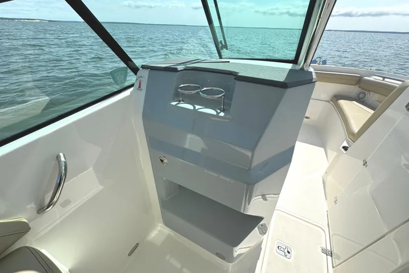Slide: The Image of Interior of 2020 Pursuit DC 235 Dual Console boat with wooden flooring. - 25