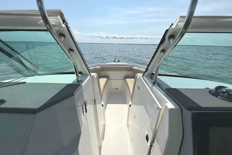 Slide: The Image of 2020 Pursuit DC 235 Dual Console boat interior with steering wheel and seating. - 27