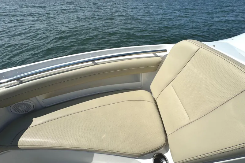 Slide: The Image of 2020 Pursuit DC 235 Dual Console boat interior with beige seating and compass design flooring. - 29