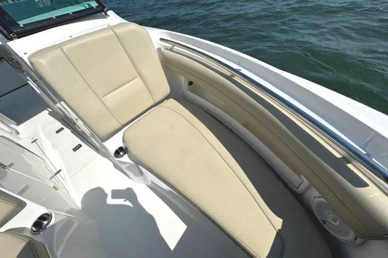 Slide: The Image of 2020 Pursuit DC 235 Dual Console anchor compartment with open hatch on water. - 32