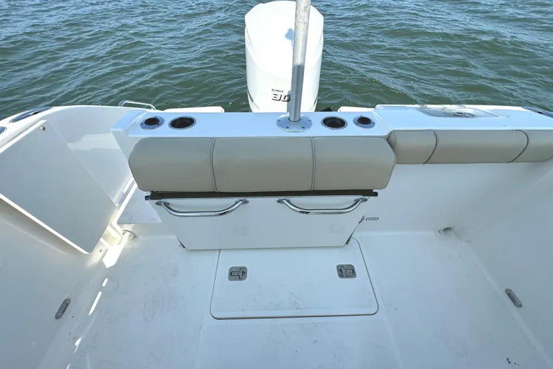 Slide: The Image of 2020 Pursuit DC 235 Dual Console boat cruising on a serene lake. - 7