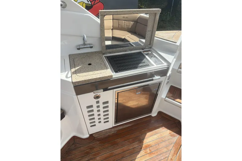 Slide: The Image of Outdoor kitchen on 2016 Sea Ray 350 SLX boat with grill and sink. - 12