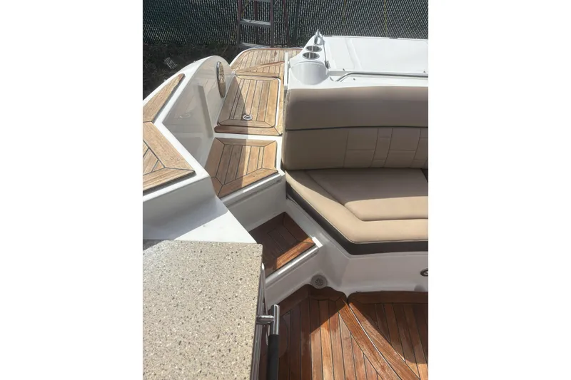 Slide: The Image of 2016 Sea Ray 350 SLX boat interior with teak flooring and beige seating. - 14