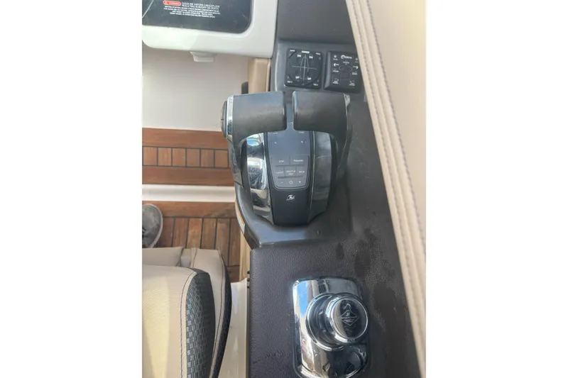 Slide: The Image of Control panel of a 2016 Sea Ray 350 SLX boat, featuring throttle and joystick. - 19