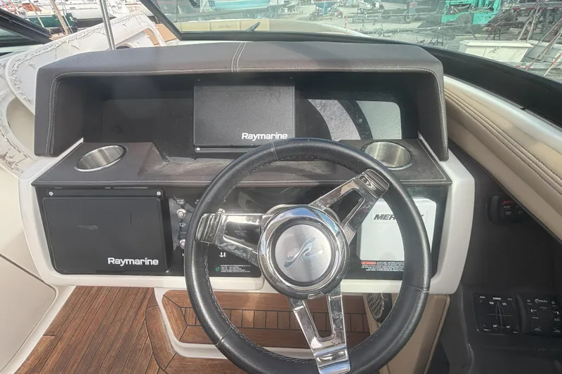 Slide: The Image of Steering wheel and dashboard of 2016 Sea Ray 350 SLX boat with Raymarine electronics. - 20