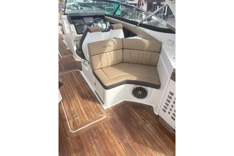 Slide: The Image of 2016 Sea Ray 350 SLX boat interior with tan seating and wooden flooring. - 21