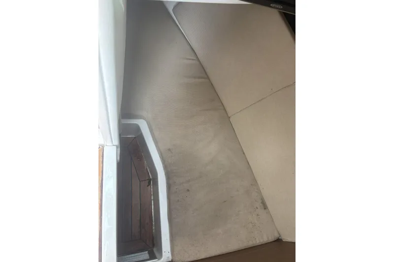 Slide: The Image of Interior seating area of a 2016 Sea Ray 350 SLX boat with beige cushions. - 22