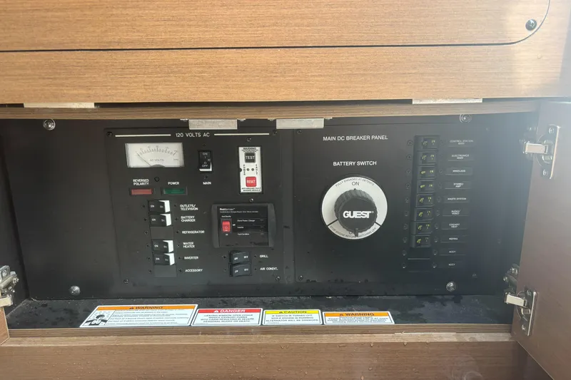 Slide: The Image of Electrical panel of a 2016 Sea Ray 350 SLX boat with various switches and controls. - 25