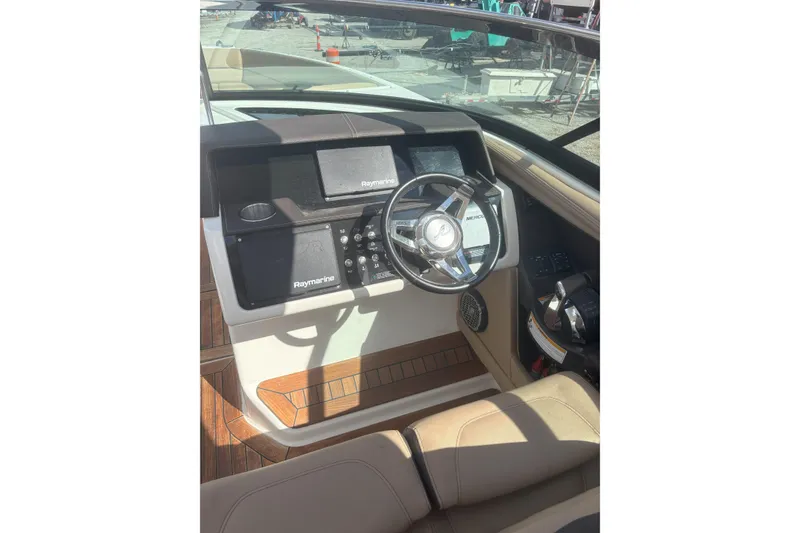 Slide: The Image of Helm of 2016 Sea Ray 350 SLX with Raymarine electronics and leather seating. - 3