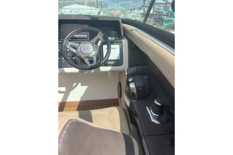 Slide: The Image of 2016 Sea Ray 350 SLX boat helm with Raymarine steering and control panel. - 4