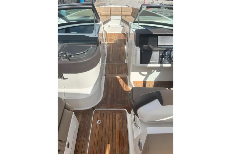 Slide: The Image of 2016 Sea Ray 350 SLX boat interior with wood flooring and modern dashboard. - 5