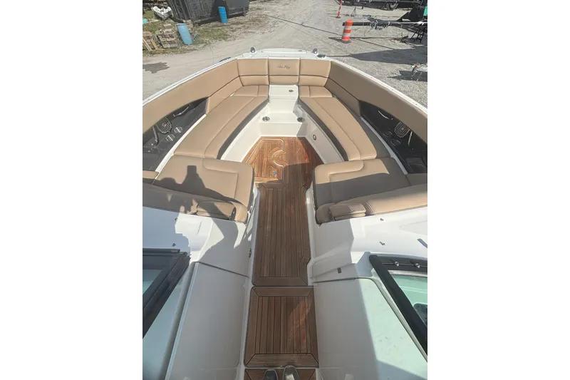 Slide: The Image of 2016 Sea Ray 350 SLX boat with tan seating and wooden deck. - 6
