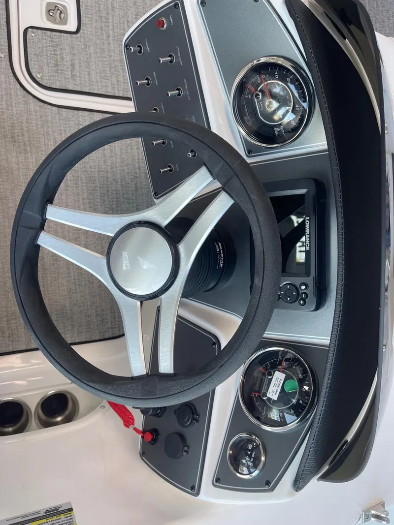 Slide: The Image of 2023 Hurricane SunDeck Sport 192 RL OB dashboard with steering wheel and gauges. - 13