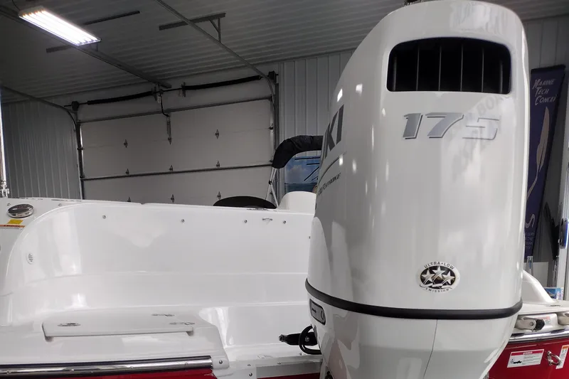 Slide: The Image of 2023 Hurricane SunDeck Sport 192 RL OB boat with Suzuki 175 outboard motor in a garage. - 4