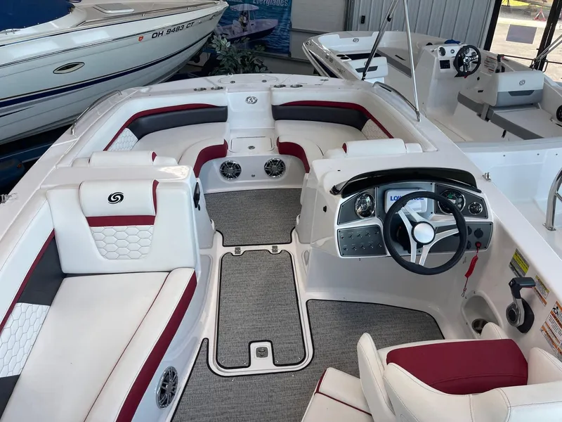 Slide: The Image of 2023 Hurricane SunDeck Sport 192 RL OB boat interior with red and white seating and modern dashboard. - 5
