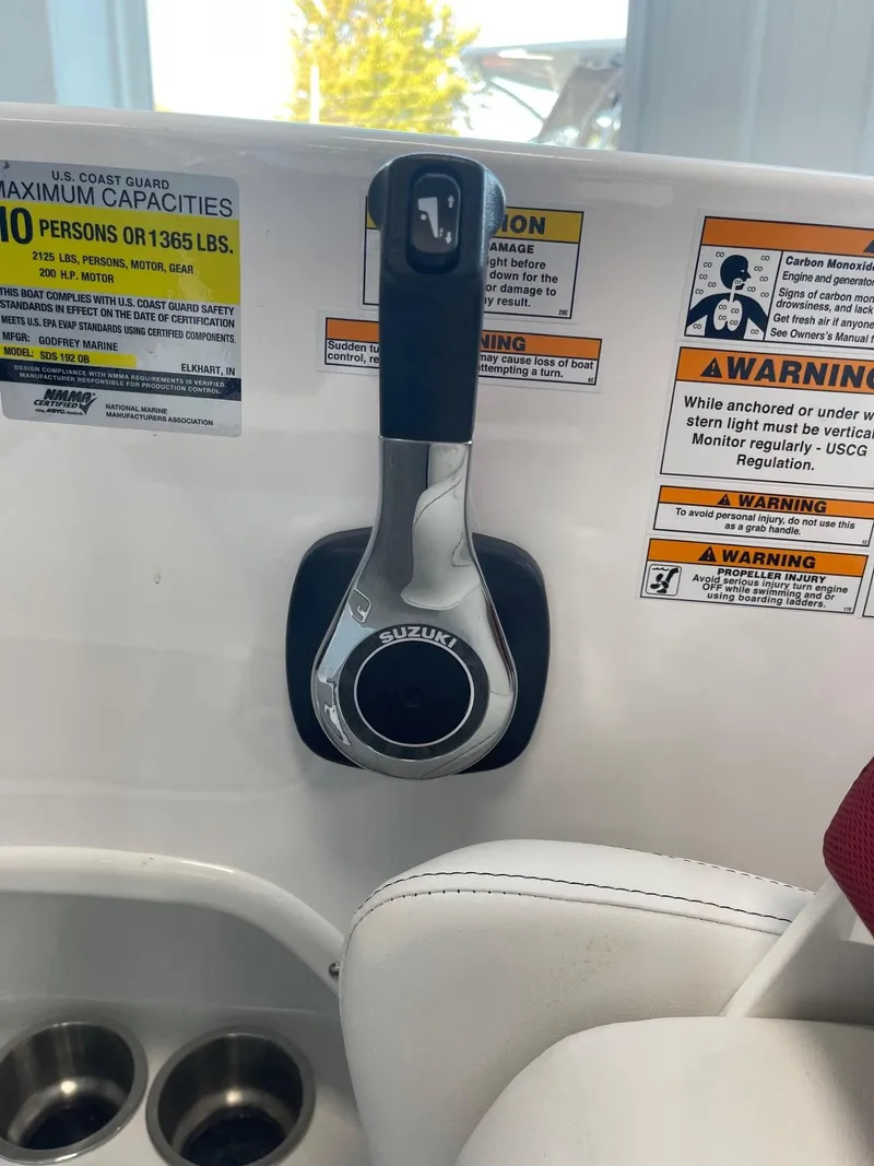 Slide: The Image of 2023 Hurricane SunDeck Sport 192 RL OB boat throttle control with safety warnings. - 8