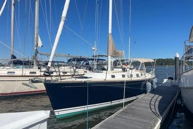 Slide: The Image of Sailboat docked at marina, Tartan 3700 model, 2001, with blue hull and white deck. - 0