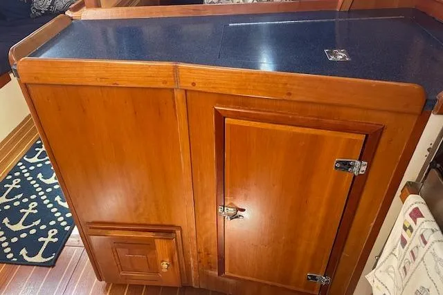 Slide: The Image of Wooden cabinetry inside a 2001 Tartan 3700 yacht, featuring a dark countertop. - 11