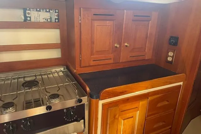 Slide: The Image of Wooden kitchen interior of 2001 Tartan 3700 yacht with stove and cabinets. - 12