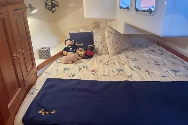 Slide: The Image of Cozy cabin interior of 2001 Tartan 3700 sailboat with floral bedding and plush toys. - 14