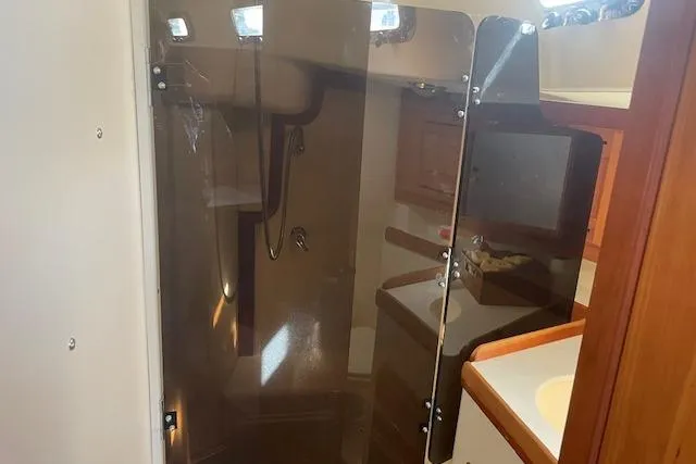 Slide: The Image of Interior of 2001 Tartan 3700 yacht bathroom with shower and wooden cabinetry. - 18