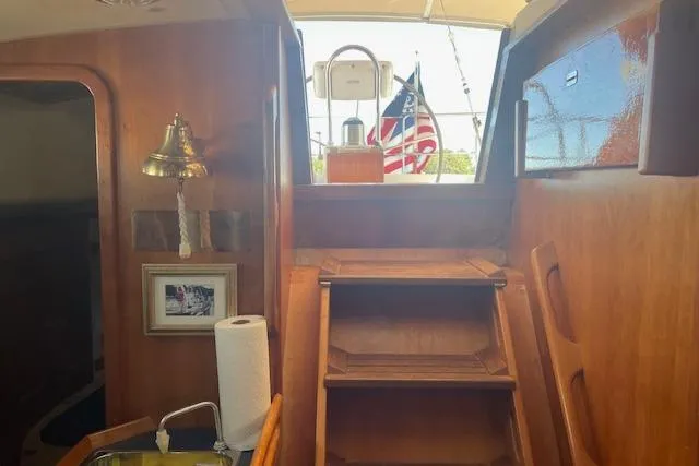 Slide: The Image of Interior of 2001 Tartan 3700 sailboat with wooden stairs and nautical decor. - 19