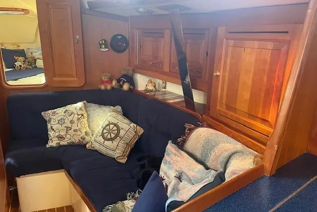 Slide: The Image of Cozy interior of 2001 Tartan 3700 sailboat with plush seating and nautical decor. - 2