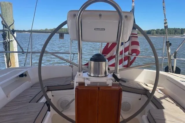 Slide: The Image of Steering wheel of 2001 Tartan 3700 sailboat with American flag in background. - 24