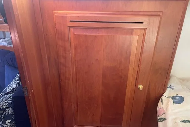 Slide: The Image of Wooden cabinet door inside a 2001 Tartan 3700 sailboat, featuring a simple design. - 7