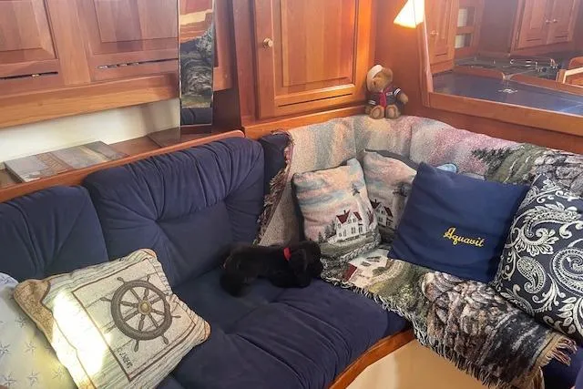 Slide: The Image of Cozy Tartan 3700 yacht interior with plush cushions and nautical decor, 2001 model. - 8