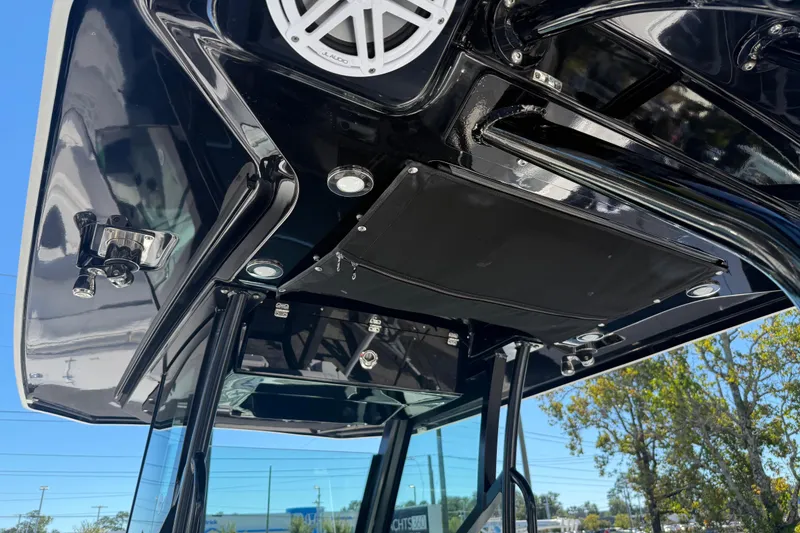Slide: The Image of 2022 Blackfin 272 CC boat's sleek black overhead console with speaker and lights. - 12