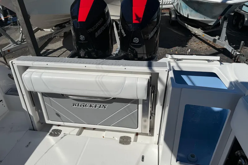 Slide: The Image of 2022 Blackfin 272 CC boat with dual Mercury outboard engines, rear seating, and storage. - 15