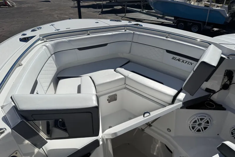 Slide: The Image of 2022 Blackfin 272 CC boat interior with white cushioned seating and sleek design. - 4