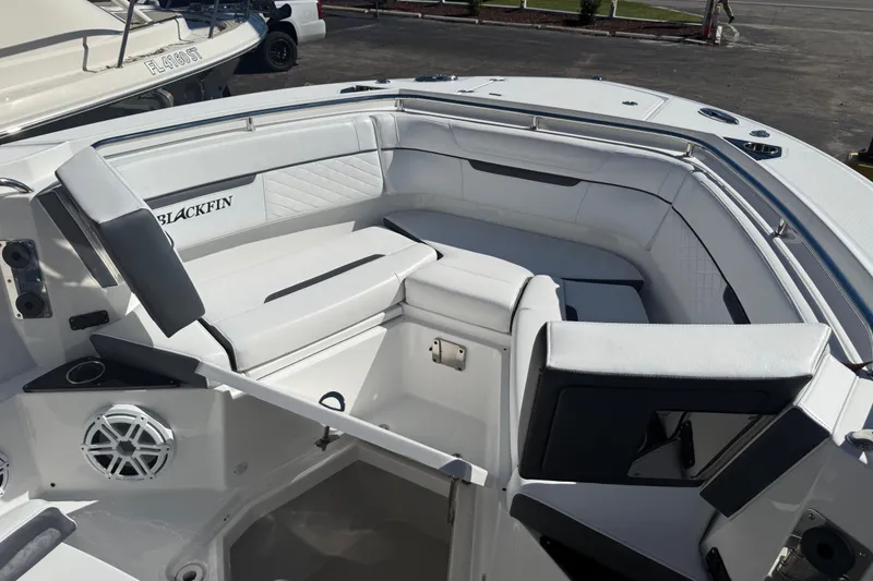Slide: The Image of 2022 Blackfin 272 CC boat interior with white seating and speaker system. - 5