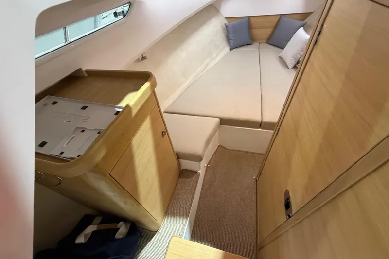 Slide: The Image of Interior of 2025 Nimbus Weekender 9, featuring cozy cabin with wooden finishes and cushions. - 10