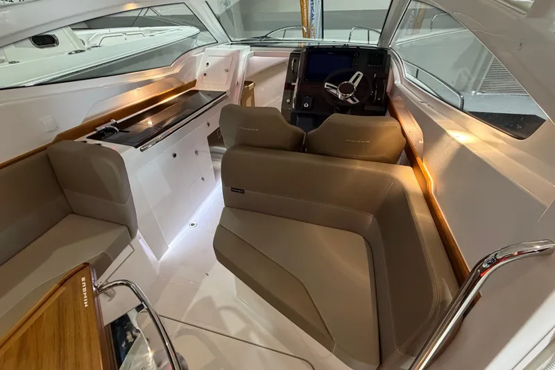 Slide: The Image of Interior of 2025 Nimbus Weekender 9 boat, featuring modern seating and sleek dashboard design. - 14