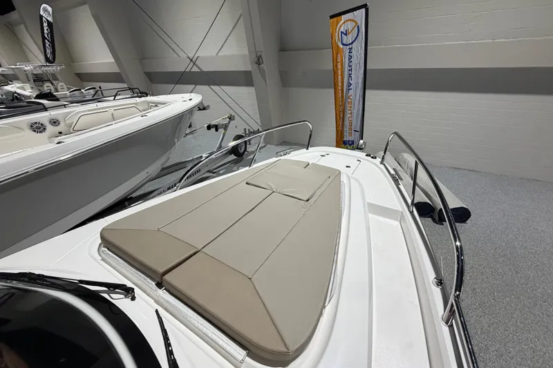 Slide: The Image of Nimbus Weekender 9 (2025) boat with cushioned deck, displayed indoors. - 5