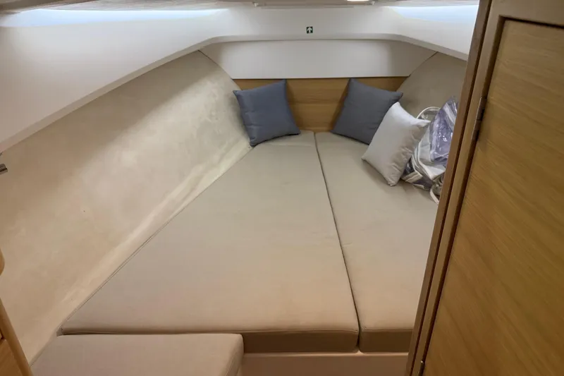 Slide: The Image of Interior cabin of 2025 Nimbus Weekender 9 with cozy bedding and cushions. - 9