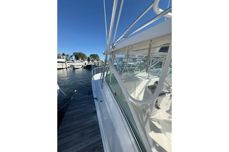 Slide: The Image of 2001 Luhrs Tournament 320 Open boat docked at marina under clear blue sky. - 3