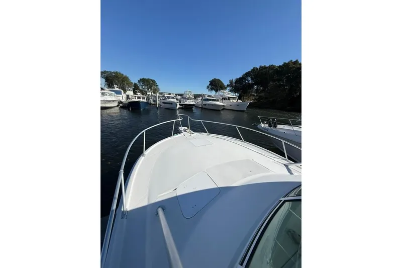 Slide: The Image of 2001 Luhrs Tournament 320 Open boat docked in a marina under clear blue sky. - 4
