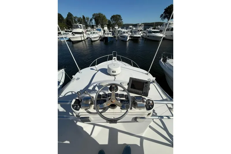 Slide: The Image of 2001 Luhrs Tournament 320 Open boat helm with marina view. - 5