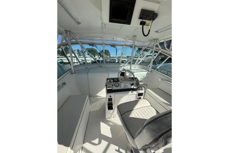 Slide: The Image of 2001 Luhrs Tournament 320 Open boat interior with helm, seating, and navigation equipment. - 7