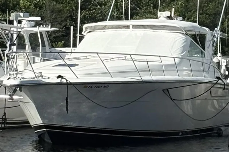 The Image of 1993 Tiara Yachts 43 Open docked, featuring sleek design and white exterior. - 0