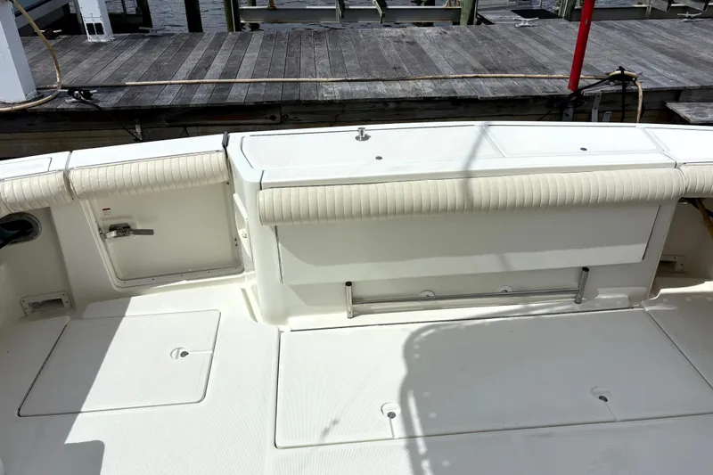 Slide: The Image of 1993 Tiara Yachts 43 Open deck with seating and storage, docked at marina. - 11