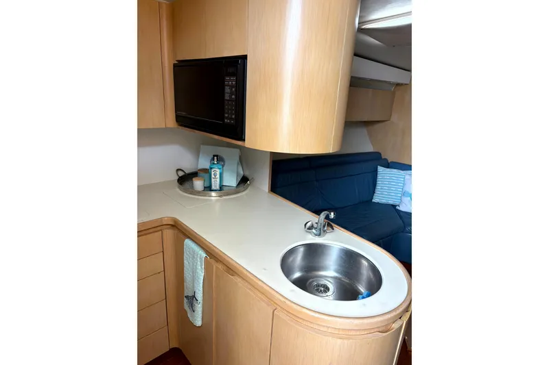 Slide: The Image of 1993 Tiara Yachts 43 Open interior with kitchenette, sink, and microwave. - 13