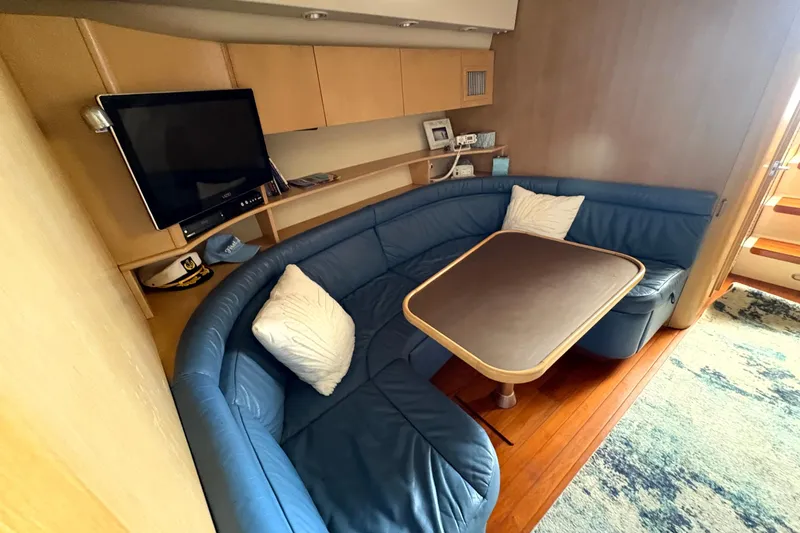 Slide: The Image of Luxurious interior of 1993 Tiara Yachts 43 Open with blue seating and wooden table. - 16