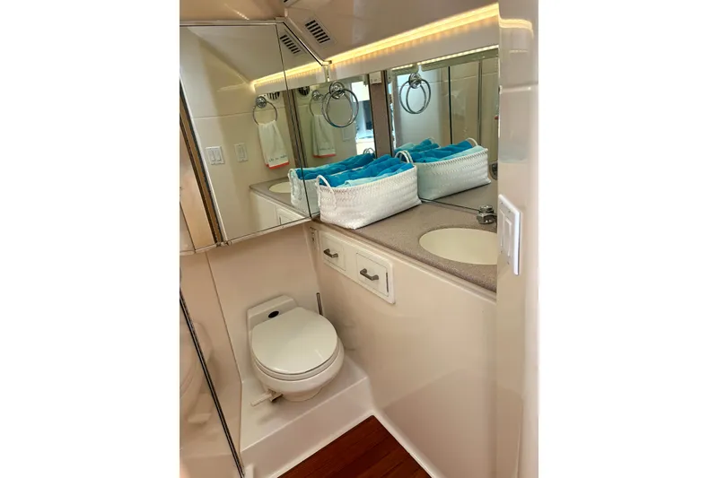Slide: The Image of Bathroom interior of 1993 Tiara Yachts 43 Open, featuring toilet and sink with mirror. - 19