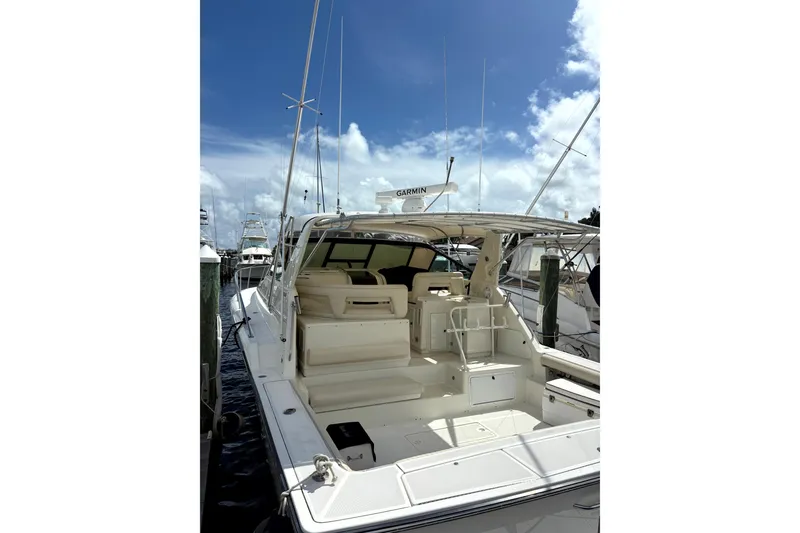 Slide: The Image of 1993 Tiara Yachts 43 Open docked under a clear blue sky. - 2